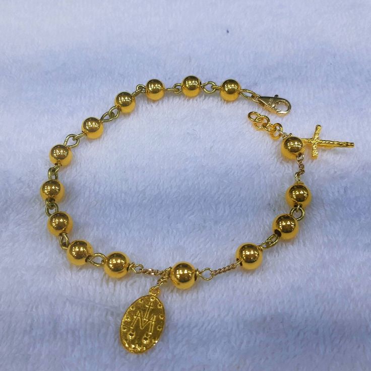 This bracelet has designed by Korean sister for her mother. Her mother lost his husband 2 months ago so daughter want to give some special gift as a Catholic. 24k gold 6mm ball has weaved by 18k solid gold wire. Crucifix and miraculous medal are 999% gold purity of 24k gold. For the safety reason, I am using 18k gold clasp,18k gold chain. Express tracking parcel will be used for delivery. If customer want lower cost and no taxes, please use my local webstore. * Material : 24K Solid gold & 18 Adjustable Gold Rosary Bracelet With Charms, Gold Rosary As A Gift, 8mm Beads Bracelet For Blessing, Yellow Gold Rosary With Round Beads, 8mm Beaded Bracelets For Blessings, Personalized Gold Rosary Bracelet As Gift, Spiritual Yellow Gold Rosary With Round Beads, Spiritual Gold Rosary Bracelet For Blessing, Spiritual Yellow Gold Charm Bracelet