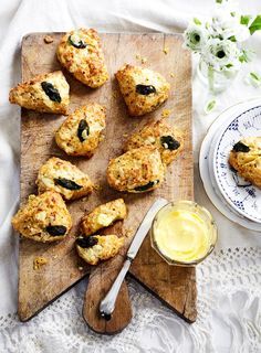 scones with olives and butter on a cutting board