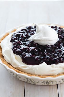 a blueberry pie with whipped cream on top