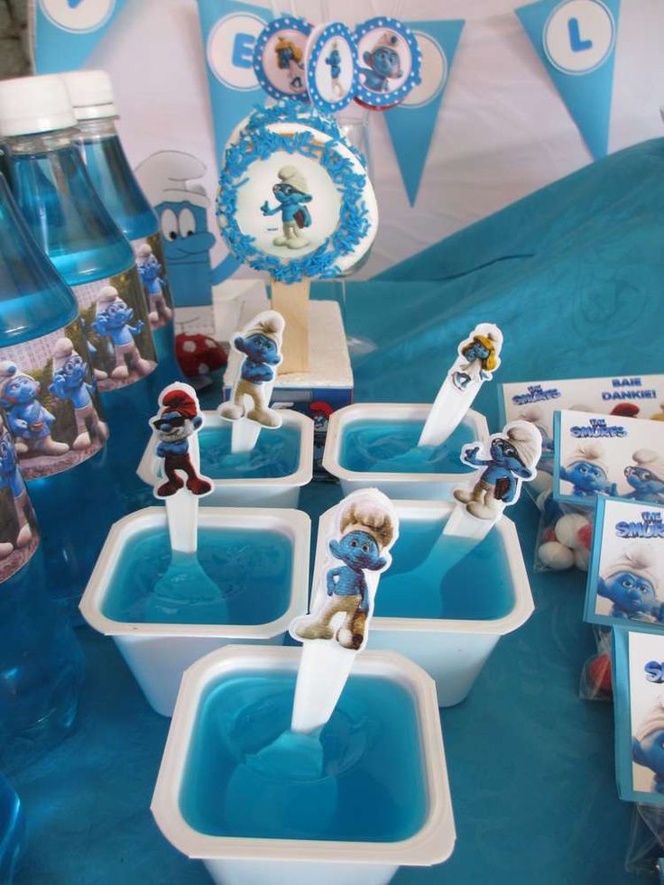 there are many blue and white items on display at the party table, including toothbrushes