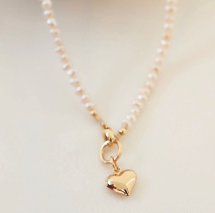 This necklace features a brass puff heart, gold-filled clasp, and freshwater pearls, all of which come together to form a beautiful and unique piece. Length: 16" Pearl Heart Necklace, Pearl Heart, Puffed Heart, Freshwater Pearl Necklace, Freshwater Pearl Necklaces, Heart Jewelry, Heart Necklace, The United States, Fresh Water