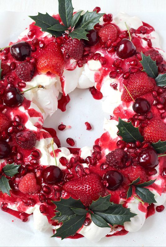 a cake decorated with berries and whipped cream