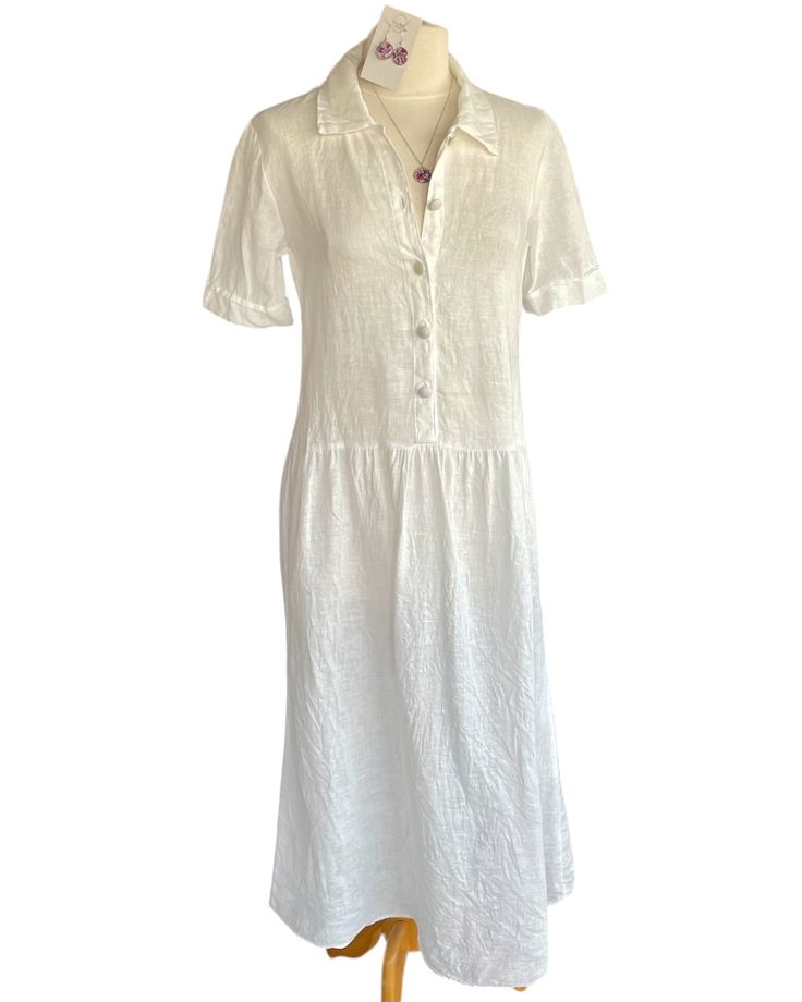 The perfect summer day dress. Relaxed fit with dropped waist, slightly tapered waist, long gathered skirt, button front closure, short sleeves, and collar. Handkerchief luxe linen, covered buttons. Small, Medium, Large Made in small batches, please allow up to 3 weeks for delivery is out of stock. Length can be shortened. For further questions or additional information, please email brigittehartdresses@gmail.com Linen Short Sleeve Shirt Dress, Short Sleeve Linen Dress With Buttons, Classic Short Sleeve Dresses With Covered Buttons, Elegant Short Sleeve Linen Dress With Buttons, Fitted Linen Dress With Button Closure And Short Sleeves, Short Sleeve Linen Shirt Dress With Button Closure, Classic Linen Dress With Short Sleeves, Elegant Short Sleeve Linen Dress For Daywear, Classic Short Sleeve Linen Dress