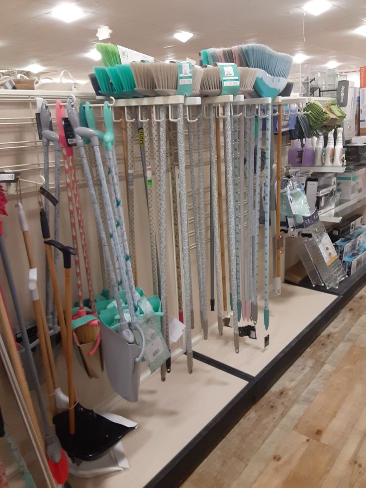 a store filled with lots of different types of brooms and mop's