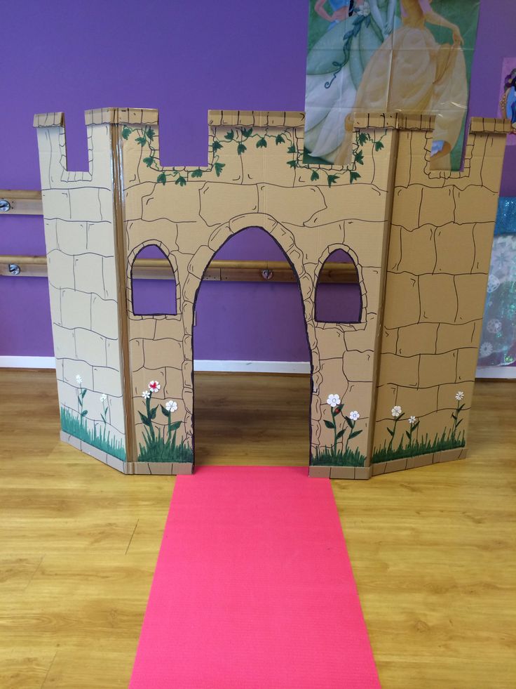 there is a pink carpet on the floor in front of a castle with a door