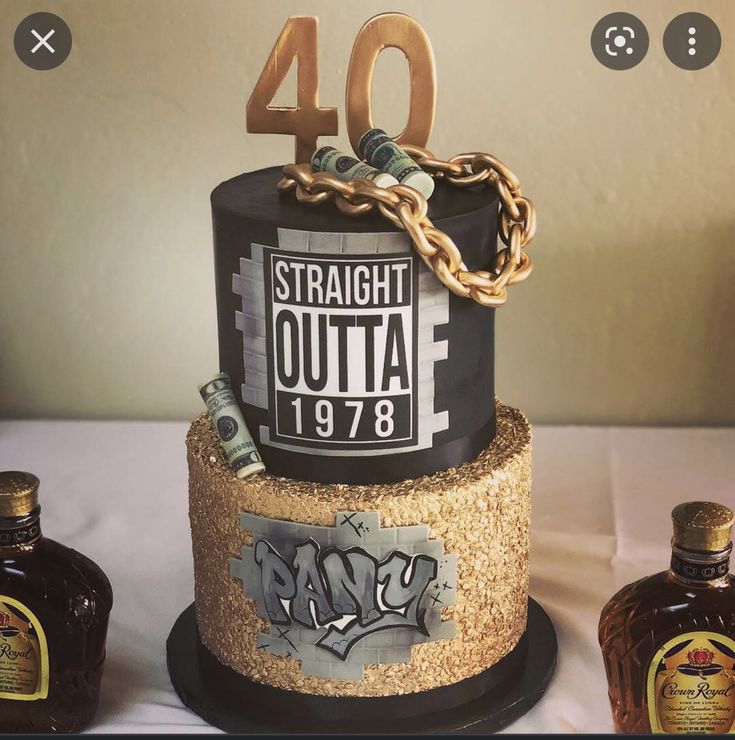 a birthday cake that is decorated with gold and black