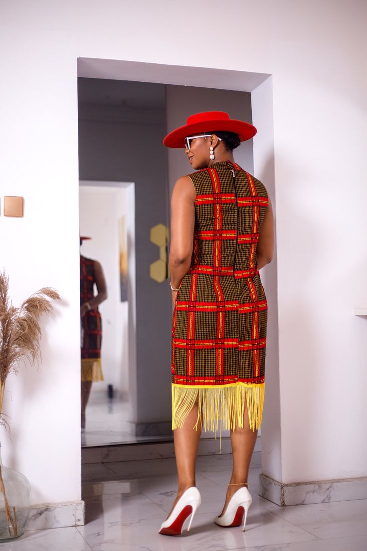 PRODUCT DETAILS: Designed in the U.S., hand-crafted in Africa Delivery within 2 weeks Print shown in Yellow, Red and Black. A relaxed fit mini dress with fringe on bottom, designed with a traditional African Ankara fabric of multicolor pattern, that gives you a style and look made for setting the trends! Can be worn for multiple formal occasions such as a dinner party or dinning or just to hang with friends out for brunch or a party! FABRIC CARE: Dry Clean. Hand Wash. SIZE CHART: Multicolor Sleeveless Fringe Dresses, Sleeveless Red Dress With Fringe, Traditional Multicolor Dresses With Tassels, Fitted Multicolor Dress With Tassels, Fitted Multicolor Dresses With Tassels, Traditional Multicolor Tassel Dress, Red Fitted Dress With Tassels, Fitted Red Dress With Tassels, Dress With Fringe