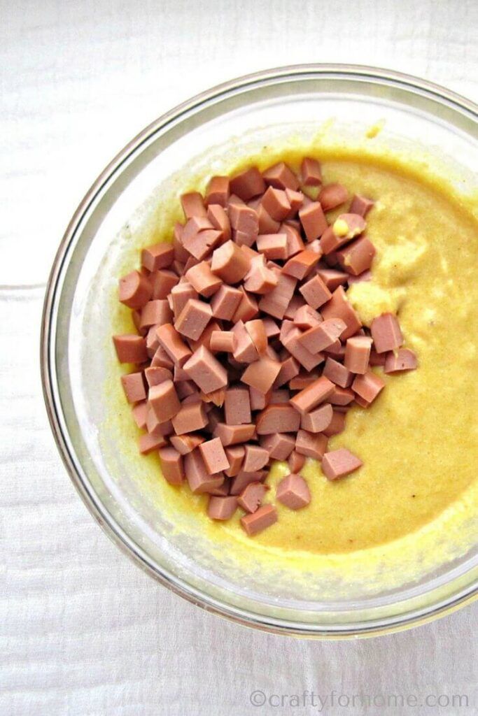 a bowl filled with chopped up food on top of a white tablecloth covered table