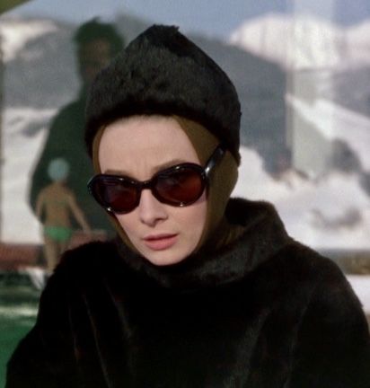 a woman wearing sunglasses and a fur coat