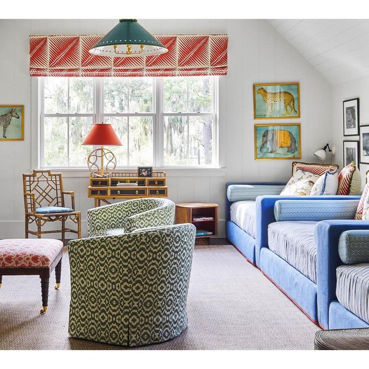 a living room filled with furniture and pictures on the wall