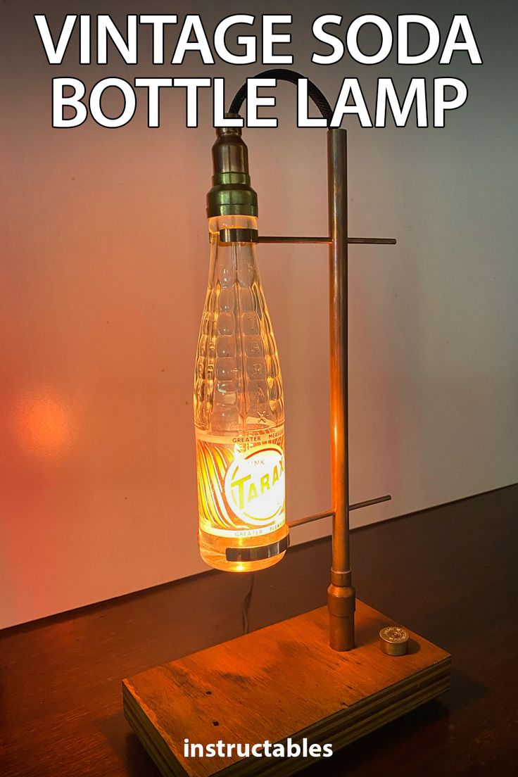 an old fashioned soda bottle lamp is turned into a table lamp with the words vintage soda bottle lamp on it