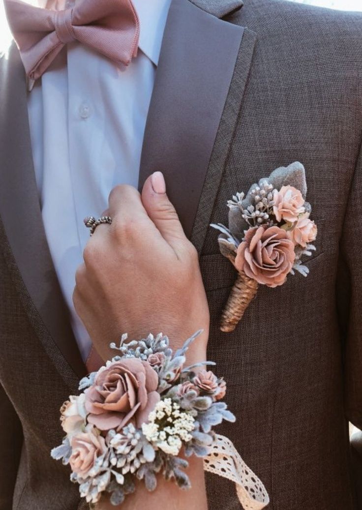 a man in a tuxedo with two boutonnieres on his lapel