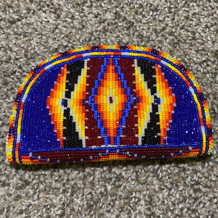 a colorful beaded purse laying on the ground