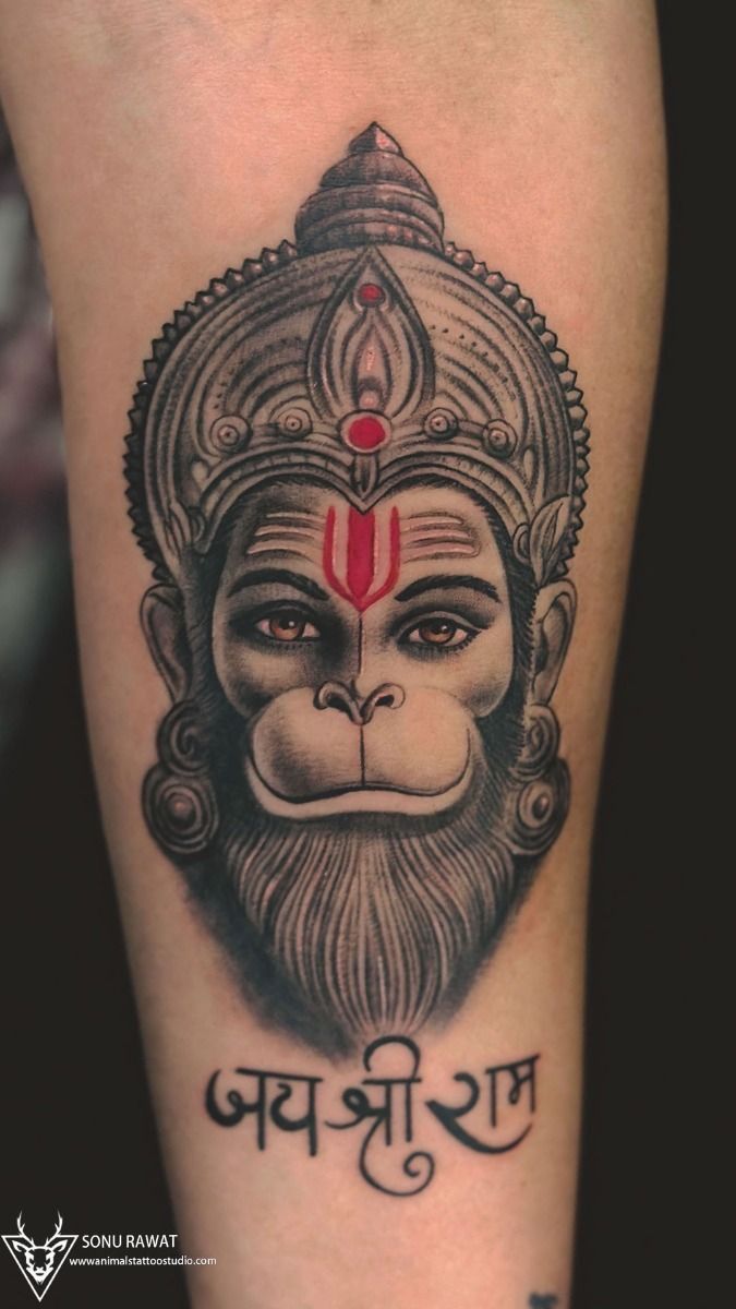 a tattoo on the leg of a person with a monkey head