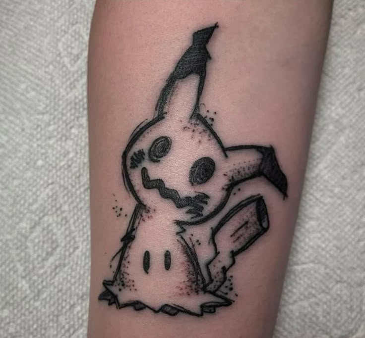 a tattoo with a cartoon character on it's arm and an arrow in the middle