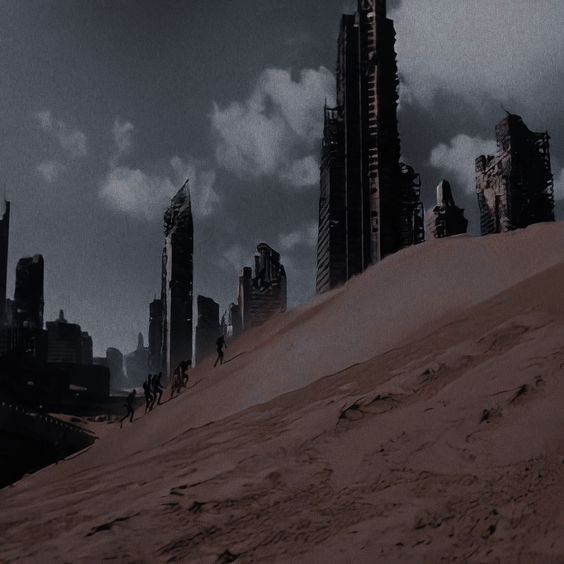 a futuristic city with tall buildings on top of a sandy hill in the foreground