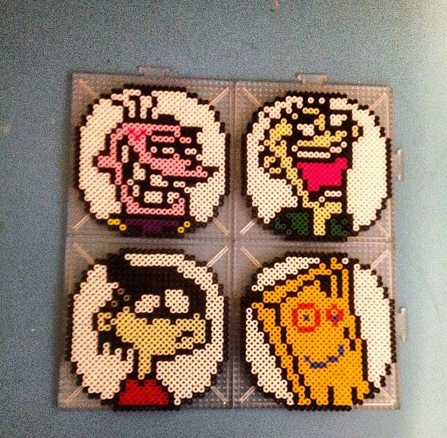 four cross stitch coasters with different cartoon characters on them, all made out of perler beads