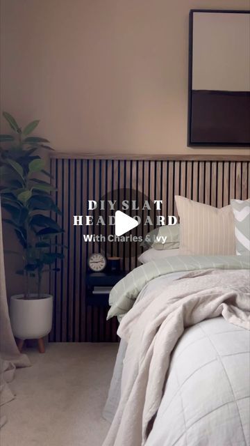 a bed sitting in a bedroom next to a plant