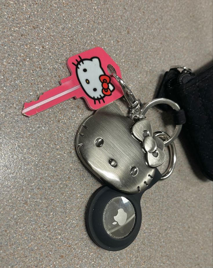 a hello kitty keychain with an apple logo on it