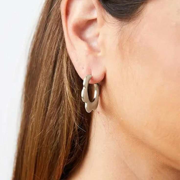 These pretty hoops add a simple statement in wintery silver. Boost the style points of an every day outfit or keep your jewelry classic if you're already dressed to the nines. Handmade in India Materials: brass Dimensions: 1.25 in. diameter With every product you purchase, you are helping provide employment, educational opportunities and medical care to artisans in India. Classic Metal Huggie Earrings For Everyday, Modern Metal Huggie Earrings For Everyday, Everyday Metal Hoop Earrings With Ear Wire, Nickel-free Metal Hoop Huggie Earrings, Nickel-free Metal Huggie Hoop Earrings, Minimalist Metal Hoop Earrings For Everyday, Modern Metal Hoop Earrings For Everyday Wear, Modern Metal Hoop Earrings For Everyday, Silver Brass Small Hoop Huggie Earrings