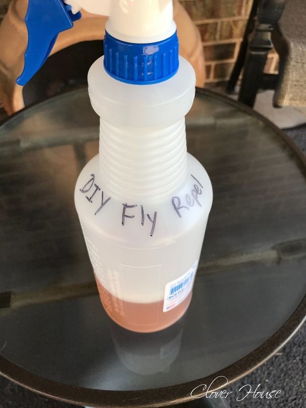 a plastic bottle with writing on it sitting on a table next to a brick wall