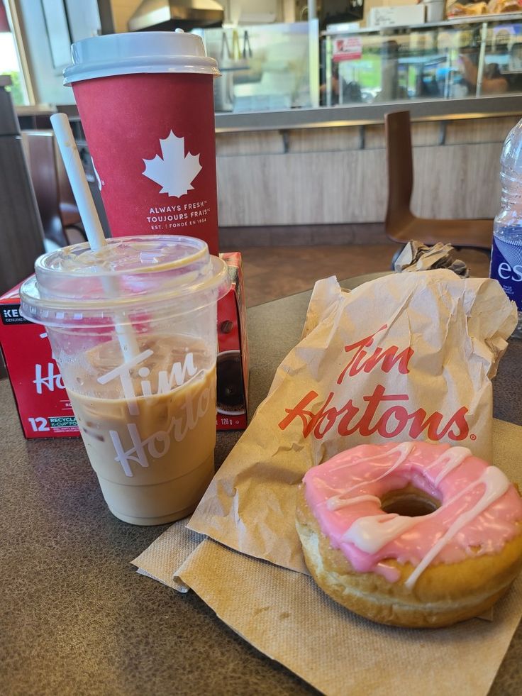 a donut and coffee are sitting on the table