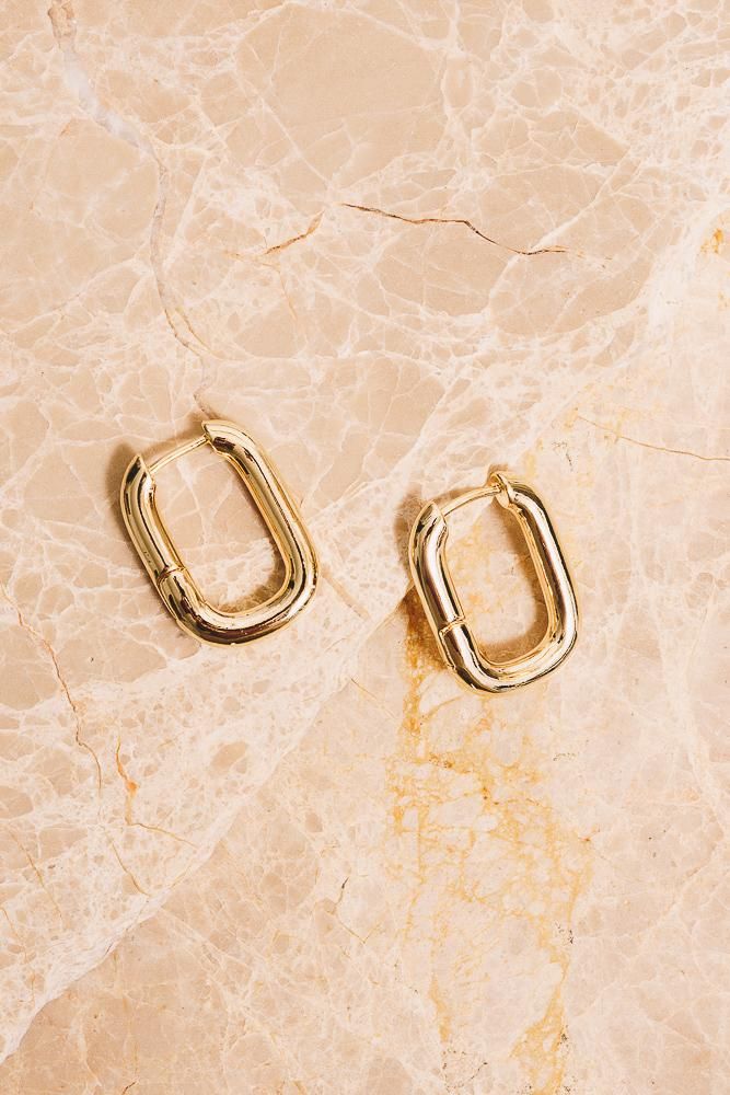 Sleek and shiny with their high polish finish, these minimal rectangular huggie hoop earrings will elevate your everyday look! Dimensions: 1" x 3/4" Materials: Alloy, 18k Gold Plating Ships in a branded jewelry pouch and box, perfect for gift giving! Huggie Hoop Earrings, Jewelry Pouch, Gift Giving, Gold Plating, Everyday Look, 18k Gold, Gold Plate, Silver Rings, Hoop Earrings