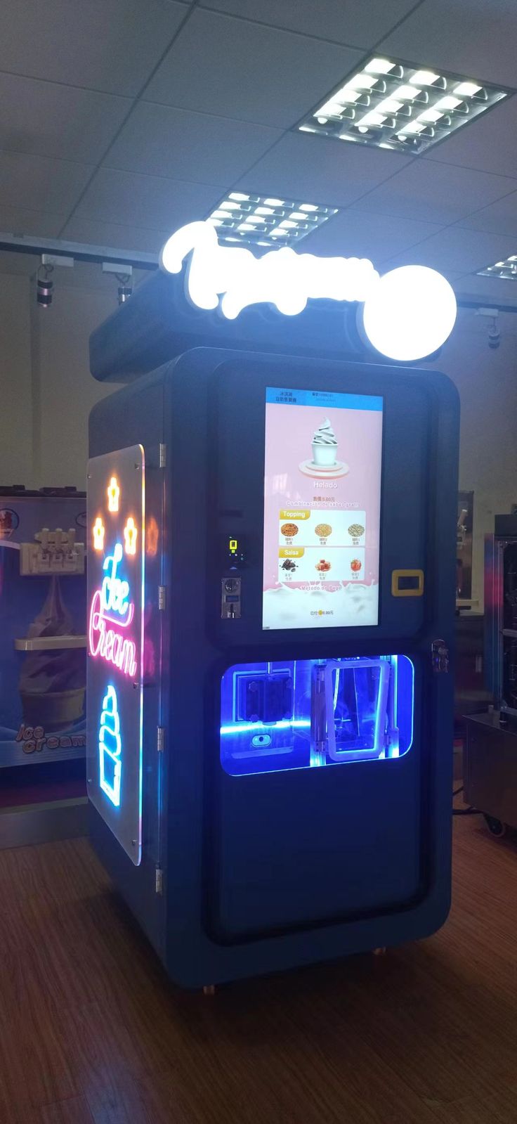 an arcade machine is lit up with blue and red lights in the middle of a room