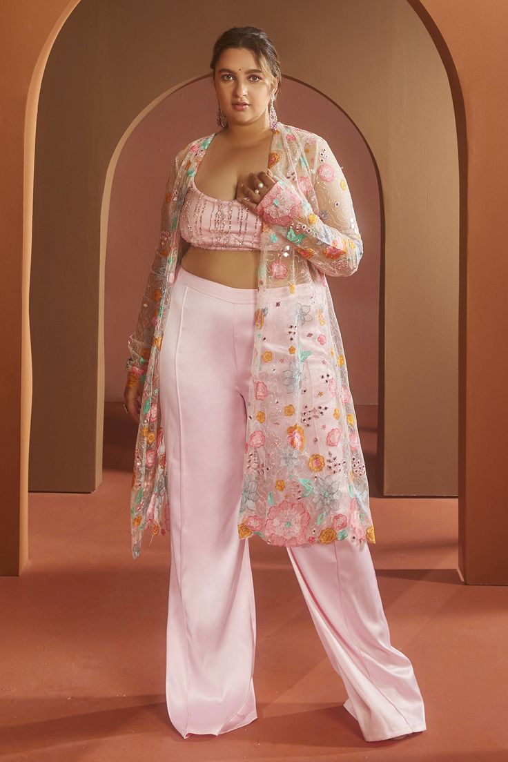 Pink full sleeve floral applique and mirror work cape. Paired with a stringy bralette style padded crop top and high-waisted straight pant.
Components: 3
Pattern: Embroidered
Type Of Work: Floral embroidery
Neckline: Straight
Sleeve Type: Long
Fabric: Organza, Satin
Color: Pink
Other Details: 
Attached lining
Approx. product weight: 1 kg
Model Height: 5ft 9inches, wearing size S
Top closure: Zip
Occasion: Mehendi and Haldi - Aza Fashions Festive Front Open Sets With Chikankari Embroidery, Bollywood Style Choli With Traditional Drape For Spring, Traditional Spring Choli With Dupatta, Designer Front Open Palazzo Set With Resham Embroidery, Spring Bollywood Choli With Dupatta, Party Long Sleeve Palazzo Set With Floral Embroidery, Designer Long Sleeve Palazzo Set With Intricate Embroidery, Designer Long Sleeve Palazzo Set With Embroidery, Bollywood Style Embroidered Long Sleeve Palazzo Set