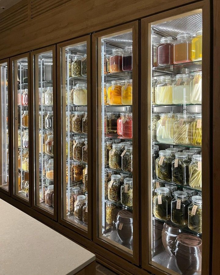 the refrigerators are filled with different types of food and drink in glass doors on both sides