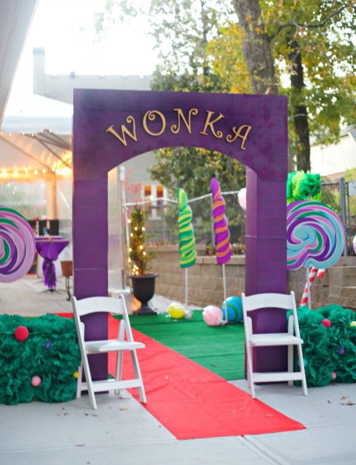 an outdoor stage set up for a children's birthday party with purple and green decorations