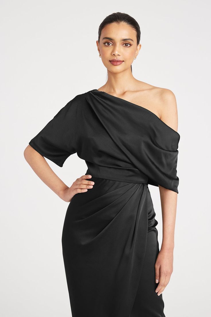 Introducing the Rayna gown, a minimal masterpiece made with smooth and elegant satin. Framed by an asymmetrical neckline, it features a one-sleeve detail and faux wrap skirt on a brilliant silhouette. Asymmetric Neckline Asymmetric Silhouette Short Sleeve Tea Length REF: 8818838 Off-shoulder Evening Gown With Satin Finish, Pre-draped Satin Dresses With Draped Sleeves, Evening Asymmetrical Dress With Ruched Bodice, Sleek Satin Evening Gown, Party Gown With Satin Finish And Asymmetrical Neckline, Party Gown With Asymmetrical Neckline And Satin Finish, Sleek Satin Dress With Fitted Bodice For Formal Events, Formal Off-shoulder Gown With Satin Finish, Sleek Evening Gown With Satin Finish