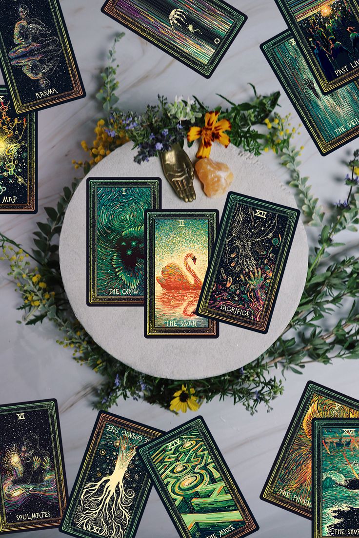 the tarot cards have been placed on top of each other with flowers and leaves around them