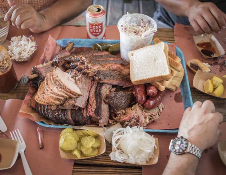 people sitting around a table with food on it