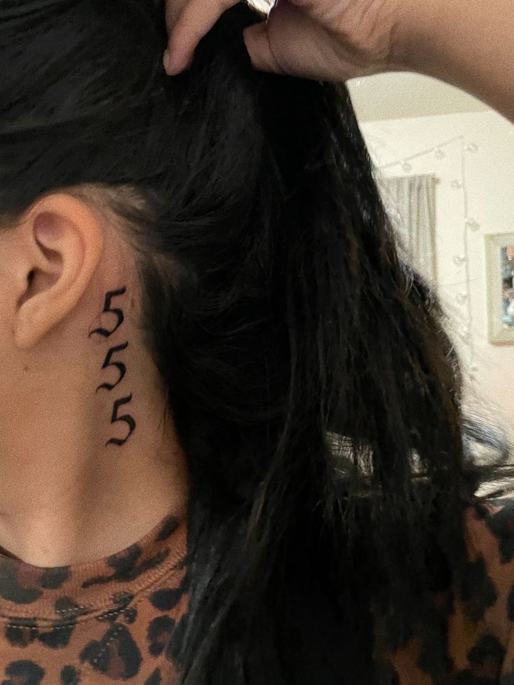 a woman with a tattoo on her neck is getting her hair done by another person