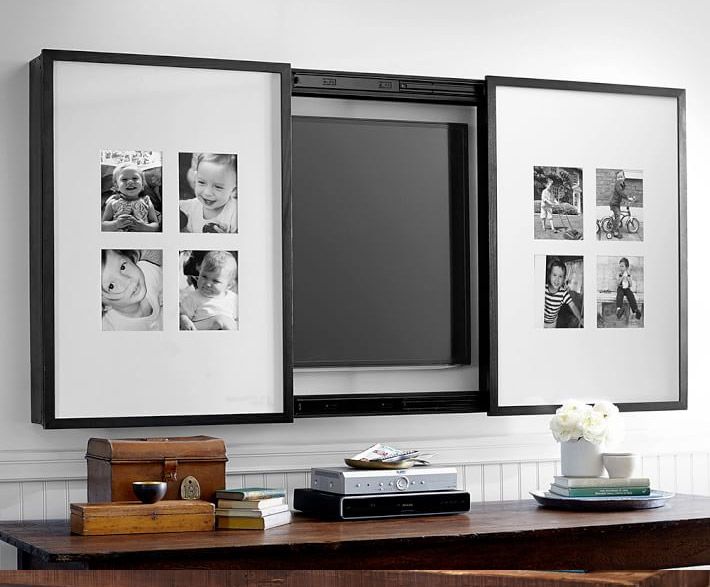 a black and white photo hanging on the wall above a mirror with multiple pictures in it