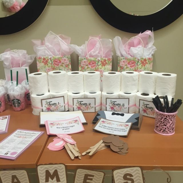 a table topped with lots of rolls of toilet paper and other items on top of it