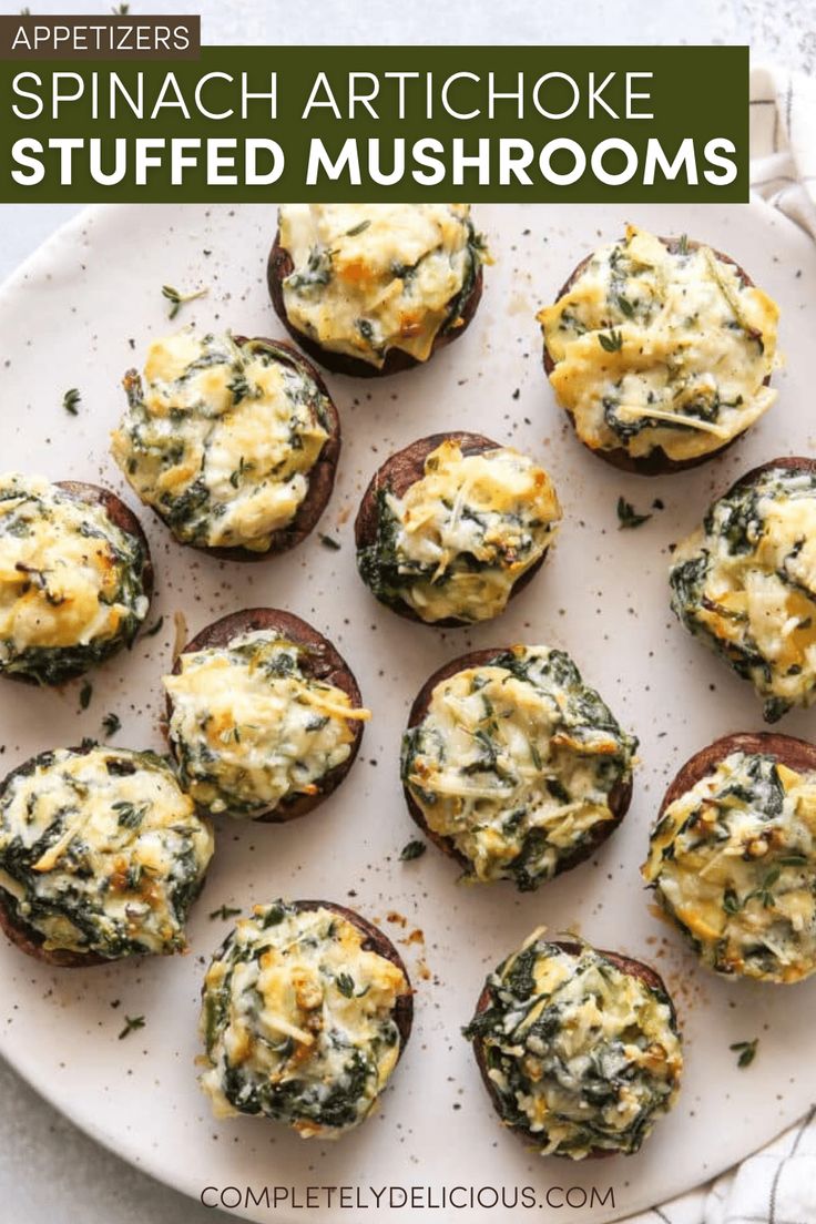 spinach artichoke stuffed mushrooms on a white plate with the title above it