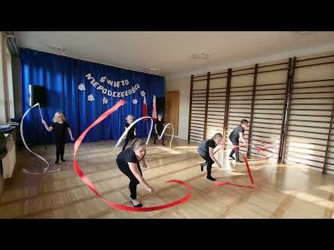 a group of people standing on top of a hard wood floor holding hoops in their hands