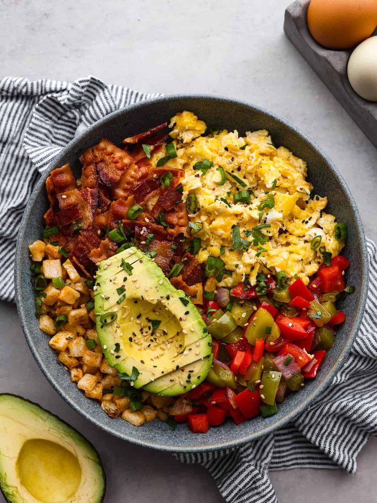 a bowl filled with eggs, beans and avocado