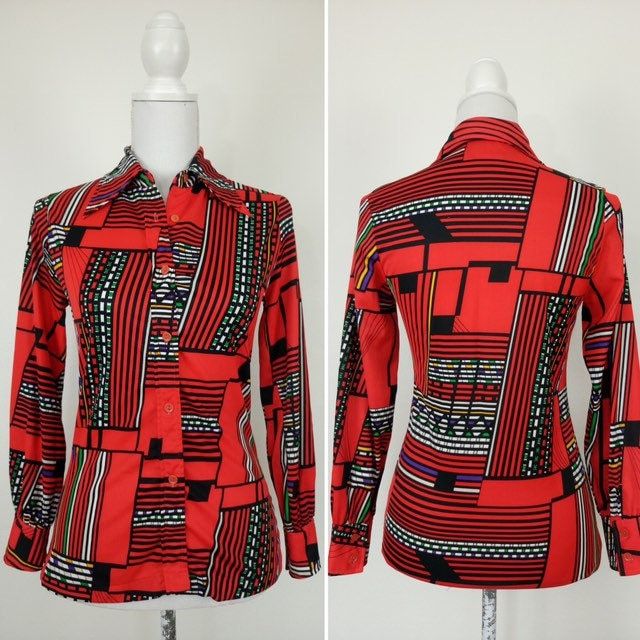 "Vintage 1970s  Red, black and white shirt in a fantastic geometric print.  Made by Walco International. Fitted style, long pointy collar. Material is stretchy polyester. Tag says size 12, best fit for a small size. Measurements lying flat and doubled: Bust: 36\" Waist: 30\" Shoulders: 14 1/2\" seam to seam Length: 25\" Sleeves length: 22 1/2\" In very good vintage condition." Bold Graphic Print Long Sleeve Tops, Bold Long Sleeve Tops With Graphic Print, Fitted Multicolor Retro Print Tops, Fitted Multicolor Tops With Retro Print, Fitted Long Sleeve Blouse With Bold Print, Fitted Patterned Printed Shirt, Fitted Collared Shirt With Geometric Pattern, Fitted Black Top With Geometric Pattern, Fitted Geometric Patterned Tops