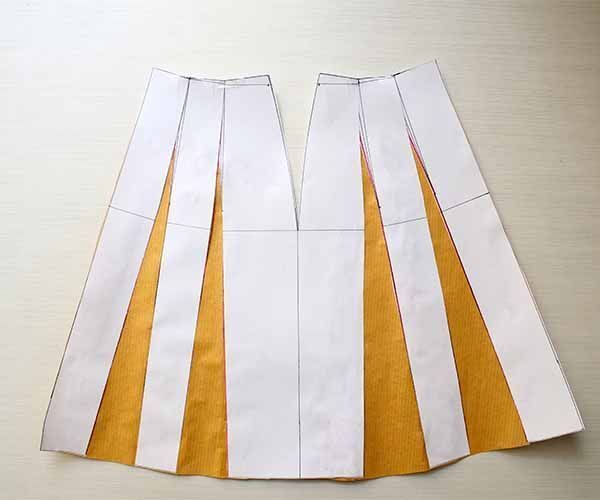 the skirt is made out of white and yellow paper, with stripes on each side