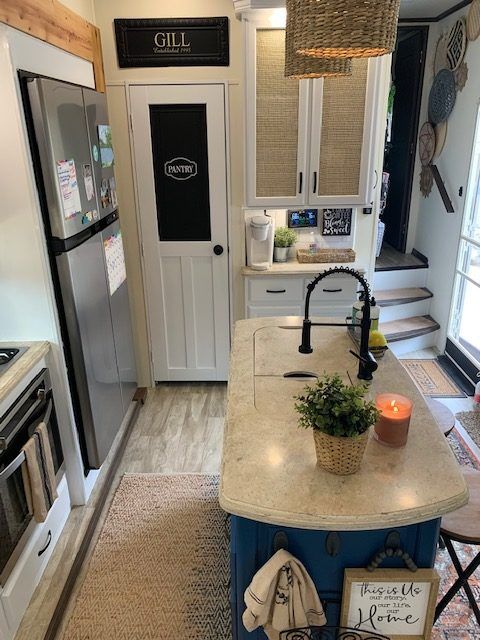 a kitchen with an island in the middle of it and a sink on the other side