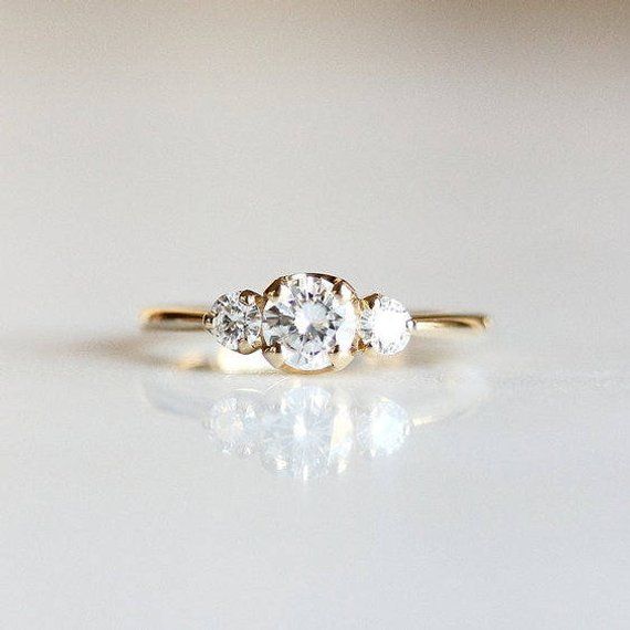 three stone engagement ring in yellow gold