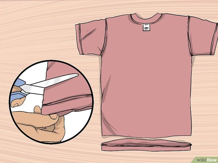 a t - shirt being cut with scissors on a wooden surface and the image shows how to