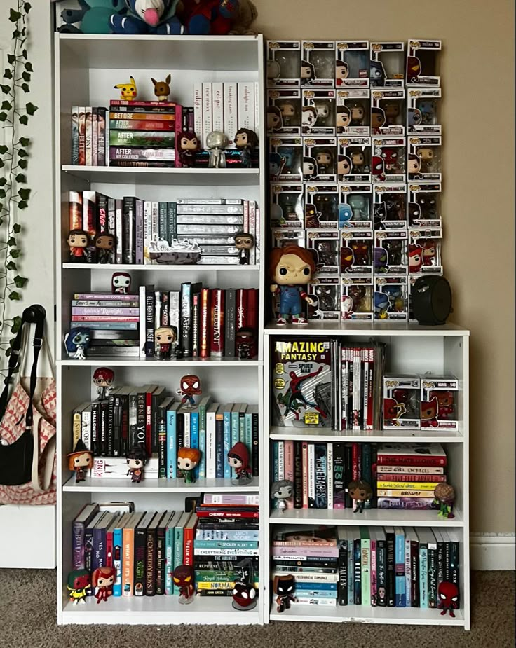 a book shelf filled with lots of books next to a plant and stuffed animals on top of it