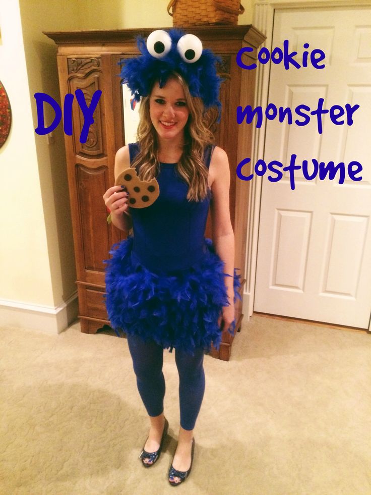 a woman in a cookie monster costume holding a cookie