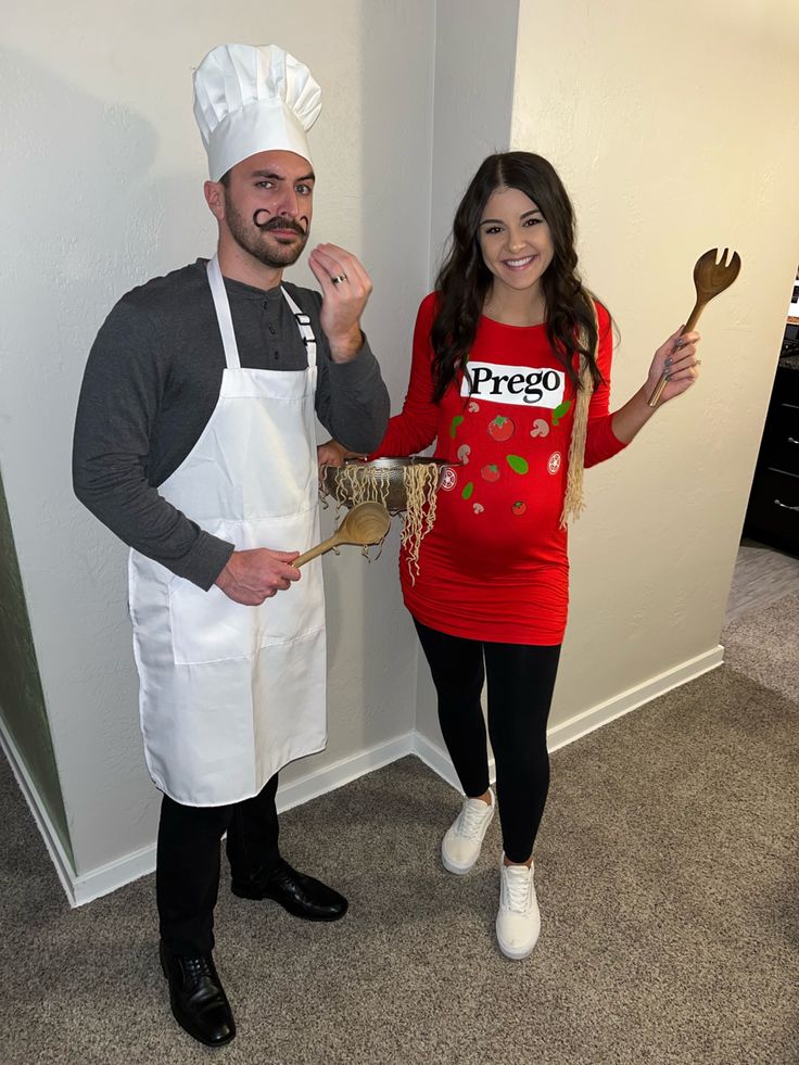 a man and woman dressed up as chefs posing for the camera while holding utensils