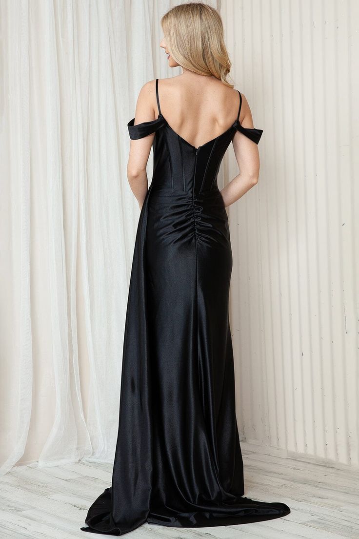 the back of a woman wearing a black evening gown