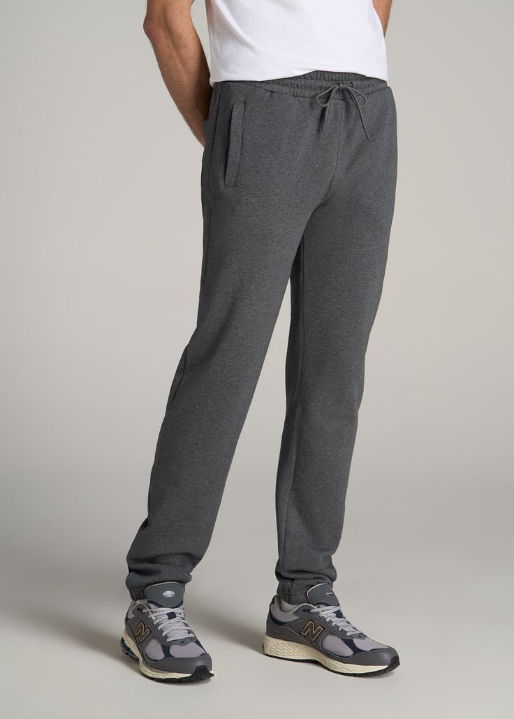 About Our Men's Extra-Long Sweatpants These tall men's sweatpants are made for bingeing Netflix on the couch and playing video games all weekend long. Tall guys have gotten the short end of the stick (literally) when it comes to comfy loungewear for years, with limited options that fit your frame. Leave the days of short inseams and awkward fits in the past and pick up a pair of sweats made exclusively for guys between 6'3” and 7'1”. Our sweatpants for tall men have an extra-long inseam with ela Long Sweatpants, Tall Men, Plus And Minus, Funny Films, Chino Jeans, Playing Video Games, Athletic Pants, Tall Guys, Pullover Men